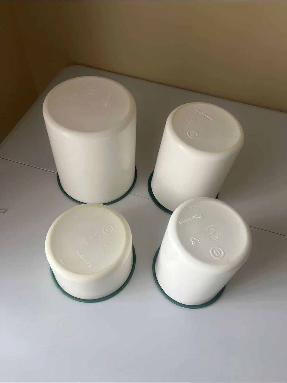 vintage one touch Tupperware Cream Containers with Dark Green Lids set of four